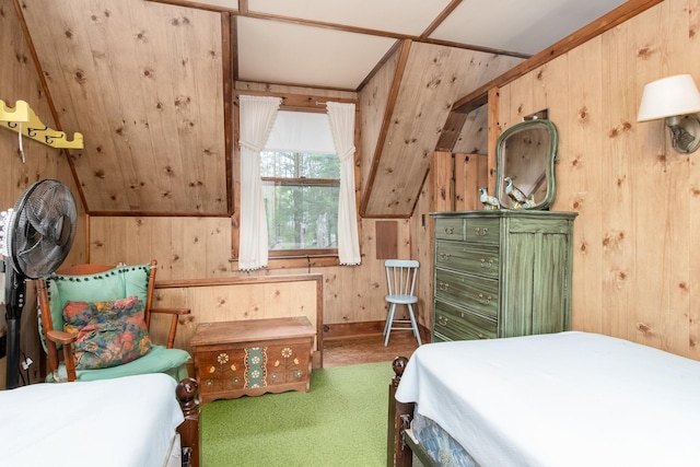 bedroom with carpet floors and wood walls