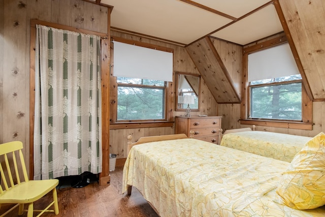 bedroom with wood finished floors and wooden walls