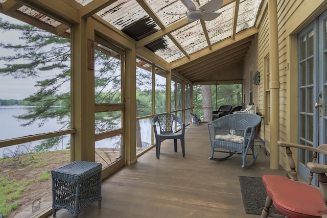 sunroom / solarium featuring lofted ceiling, a water view, and a ceiling fan