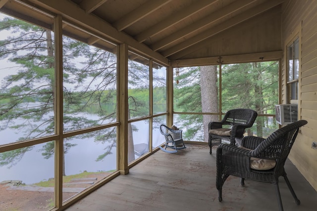 sunroom featuring lofted ceiling with beams and a water view