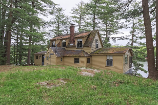 rear view of property featuring a chimney