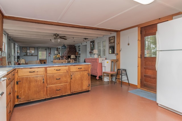 kitchen featuring a ceiling fan, open floor plan, freestanding refrigerator, brown cabinets, and light floors