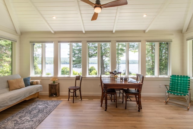 sunroom with vaulted ceiling with beams, ceiling fan, and wood ceiling