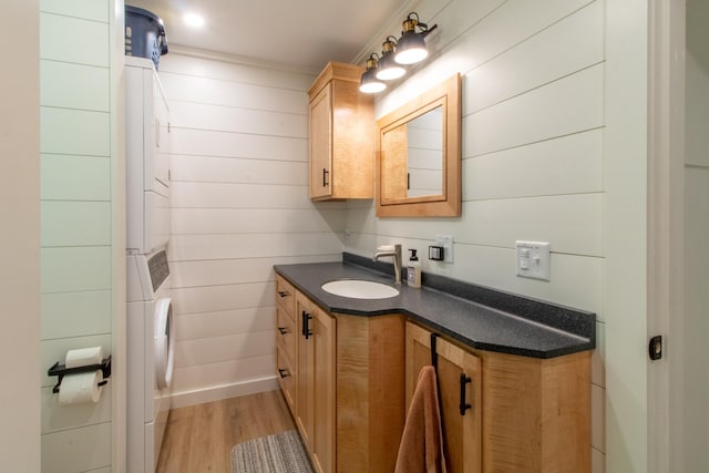 bathroom with washer / dryer, wood finished floors, and vanity