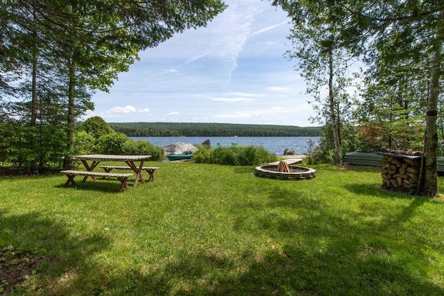 view of yard featuring a water view and a fire pit