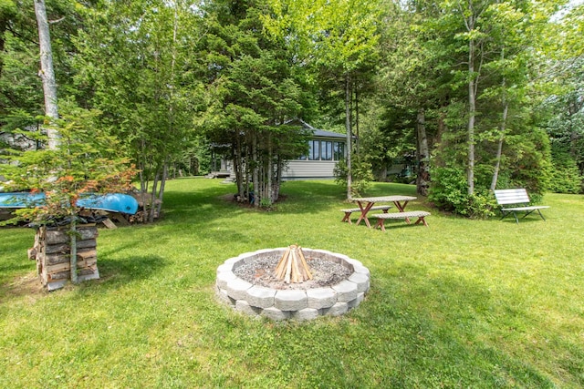 view of yard featuring an outdoor fire pit