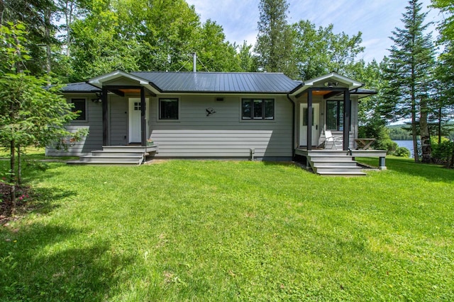 view of front of home with a front lawn and metal roof