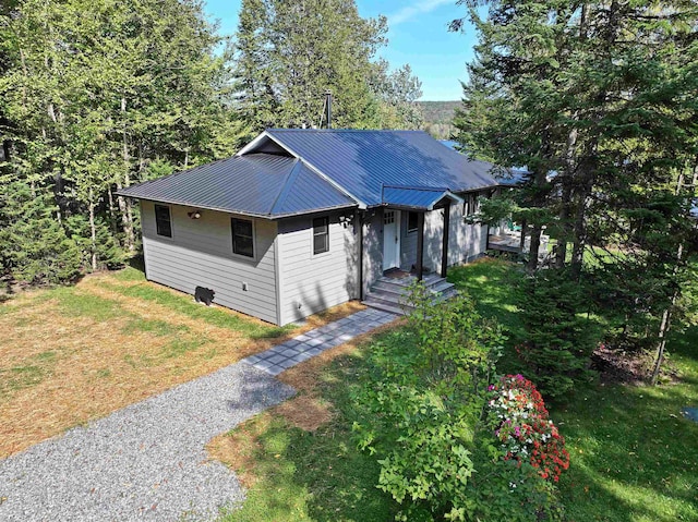 view of front facade featuring metal roof and a front lawn