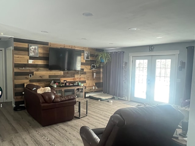 living room with recessed lighting, french doors, wooden walls, and wood finished floors