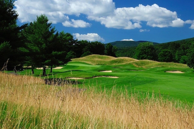 view of home's community featuring view of golf course and a mountain view