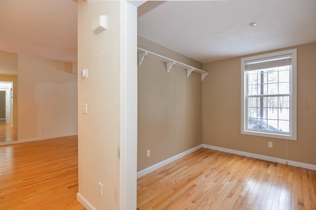 walk in closet featuring light wood-style floors and visible vents