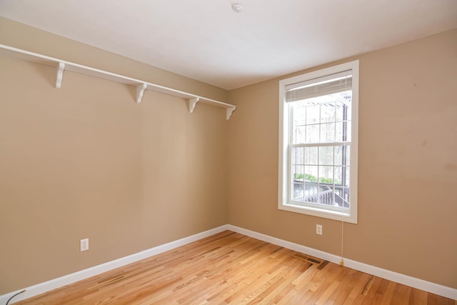 spacious closet with light wood-style flooring and visible vents