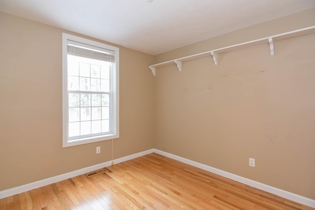 walk in closet featuring wood finished floors and visible vents