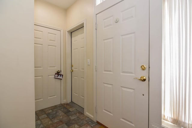 doorway to outside with stone finish floor