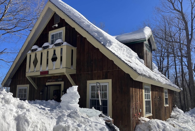 snow covered property with board and batten siding