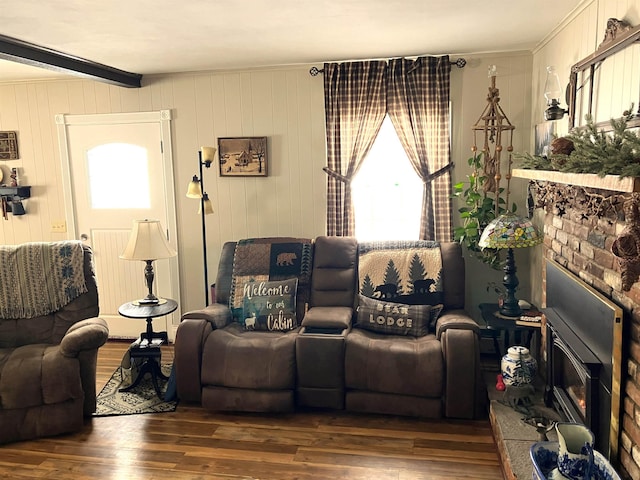 living room featuring beam ceiling and dark wood-type flooring