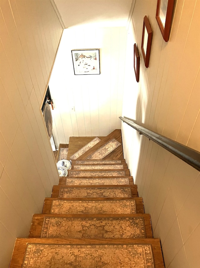 stairway with wood walls