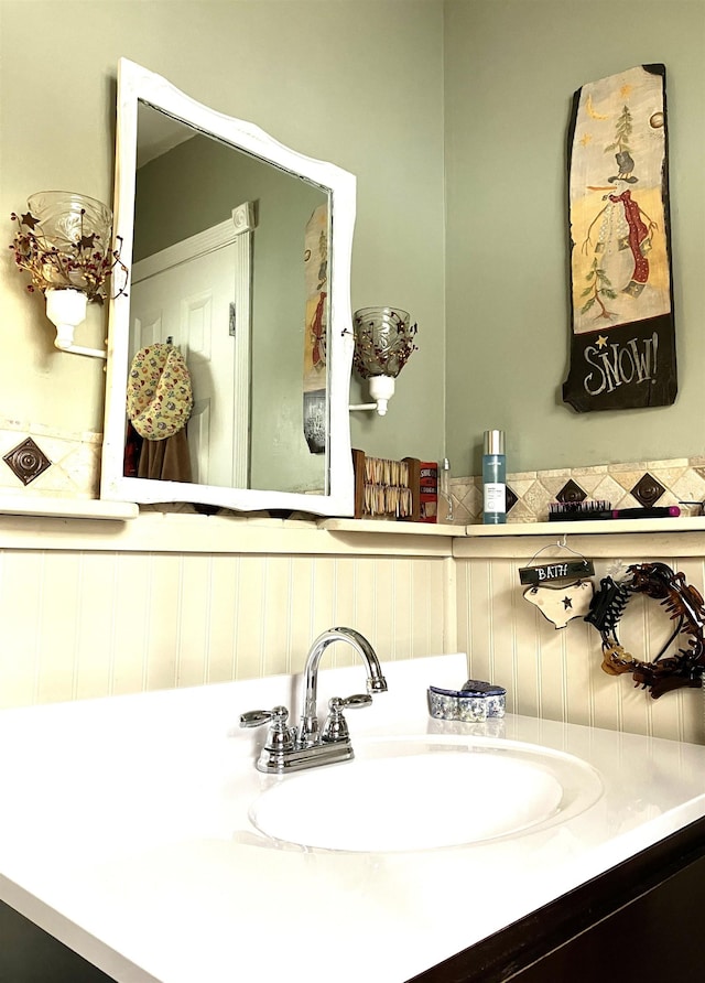 bathroom featuring a wainscoted wall and vanity