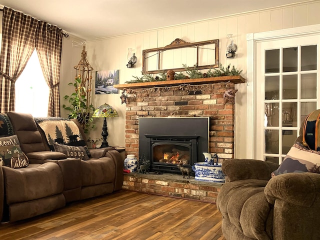 living area with a brick fireplace, wood finished floors, and wooden walls