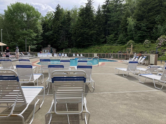 pool featuring a patio area and fence