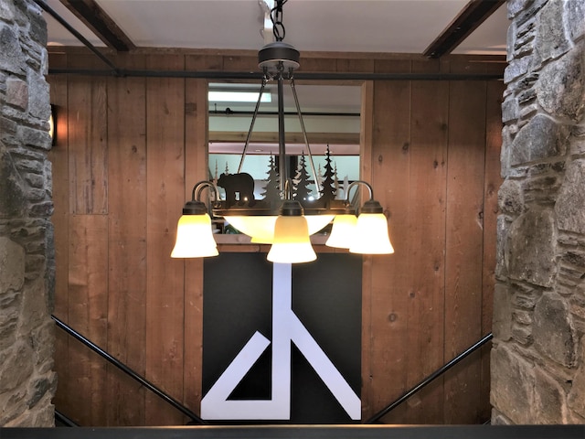 interior details featuring wood walls and beam ceiling