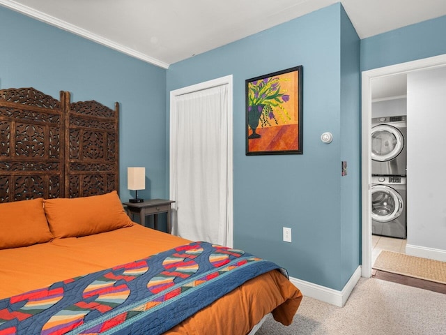 bedroom with stacked washer and dryer, a closet, carpet, and baseboards