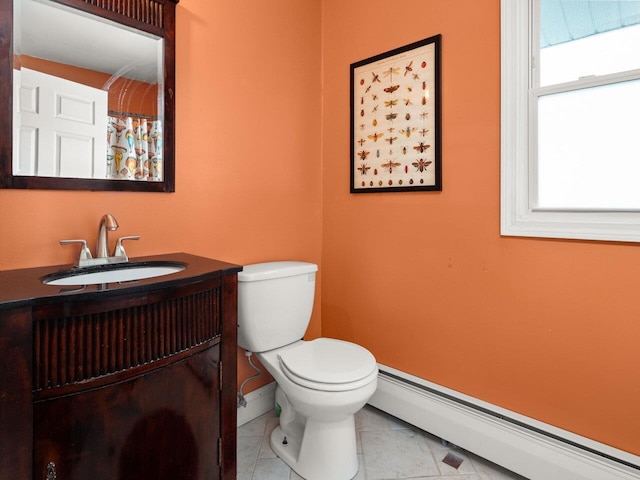 bathroom featuring tile patterned flooring, toilet, vanity, baseboards, and baseboard heating