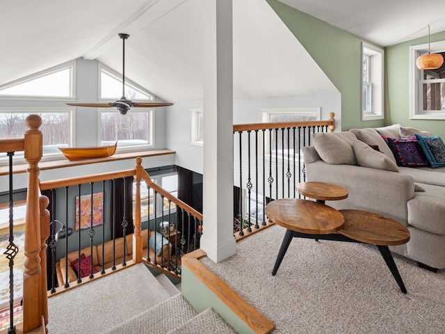 sitting room with lofted ceiling with beams, plenty of natural light, and an upstairs landing