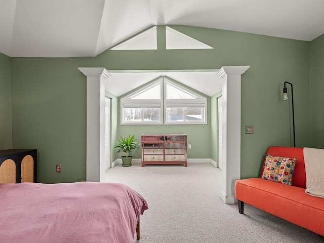 carpeted bedroom featuring vaulted ceiling, baseboards, and ornate columns