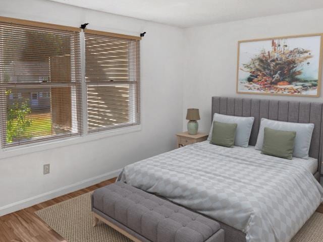 bedroom featuring wood finished floors and baseboards