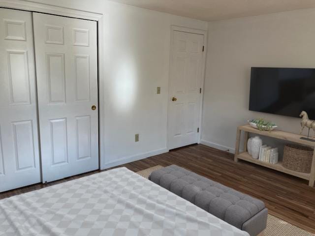 bedroom with dark wood-style flooring and baseboards