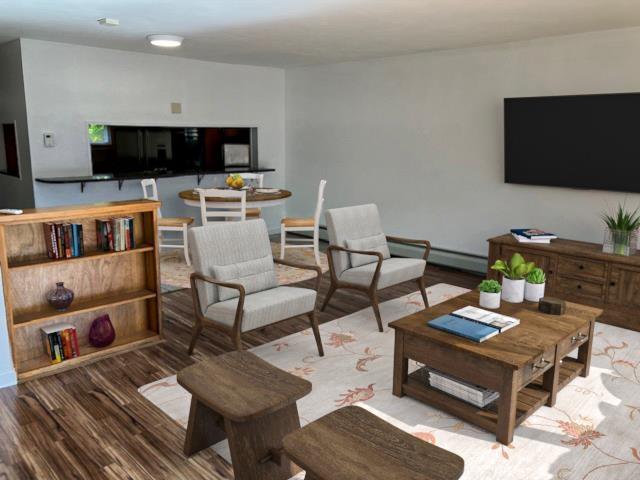 living area with a baseboard radiator and wood finished floors