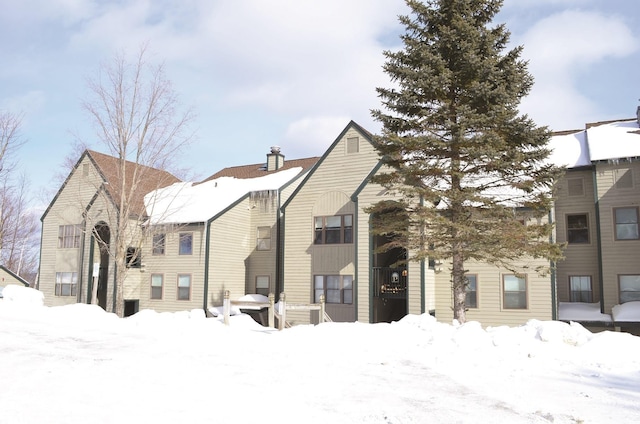 view of snow covered back of property