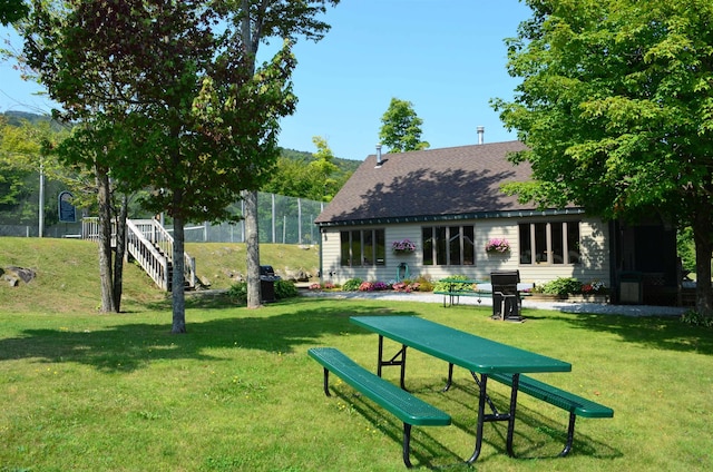 view of community featuring stairs and a yard