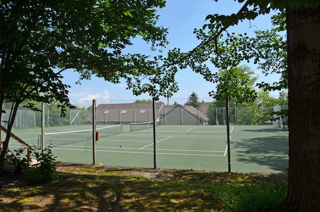 view of tennis court featuring fence