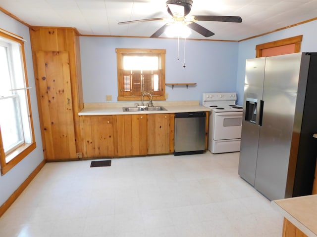 kitchen with brown cabinetry, stainless steel appliances, crown molding, light countertops, and a sink