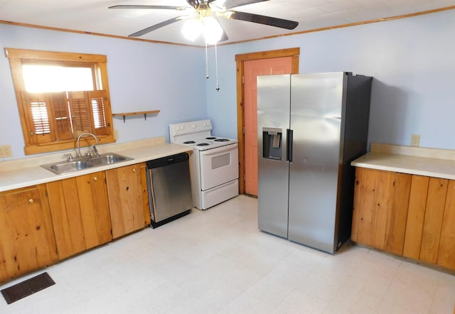 kitchen with visible vents, stainless steel appliances, light countertops, light floors, and a sink