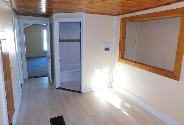 hallway featuring wooden ceiling, visible vents, and light wood finished floors