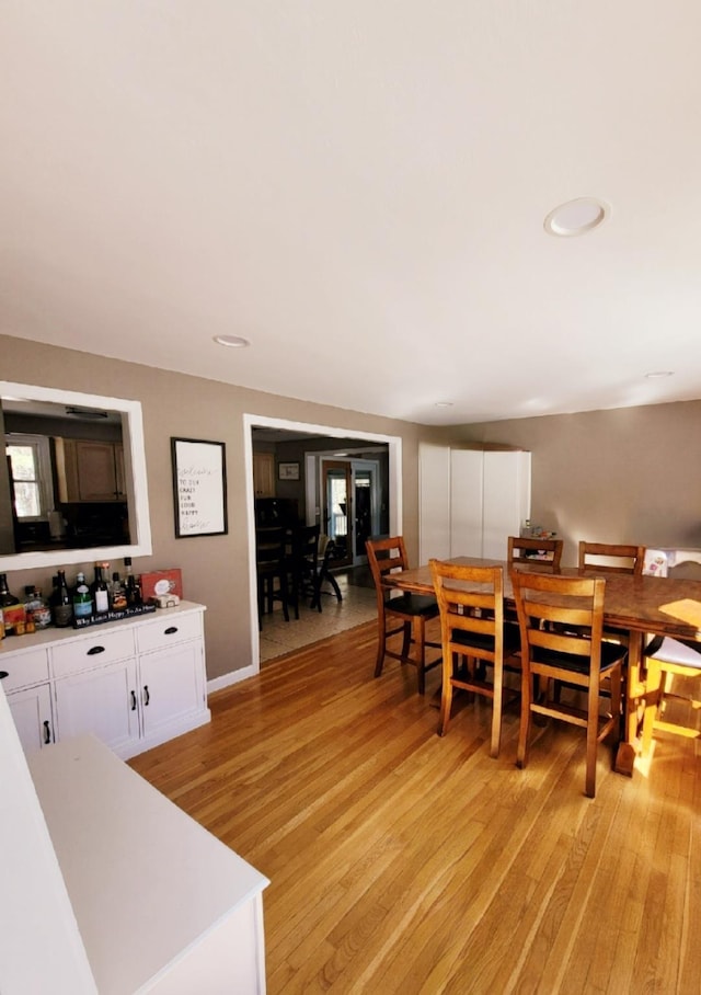 dining area featuring light wood-style flooring, recessed lighting, and baseboards