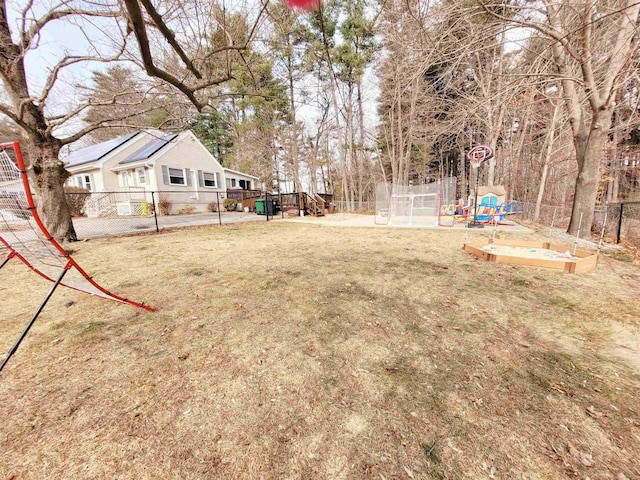 view of yard with a playground and fence