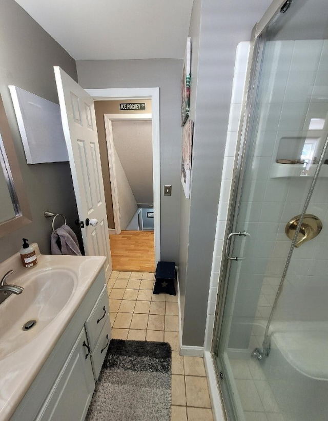 bathroom featuring vanity, tile patterned floors, and a stall shower