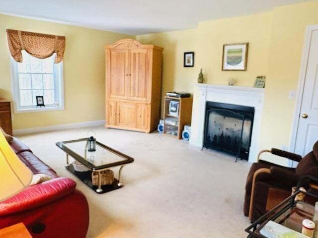 living room featuring carpet and a glass covered fireplace