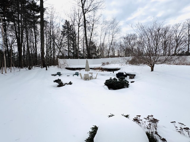 yard layered in snow with a garage