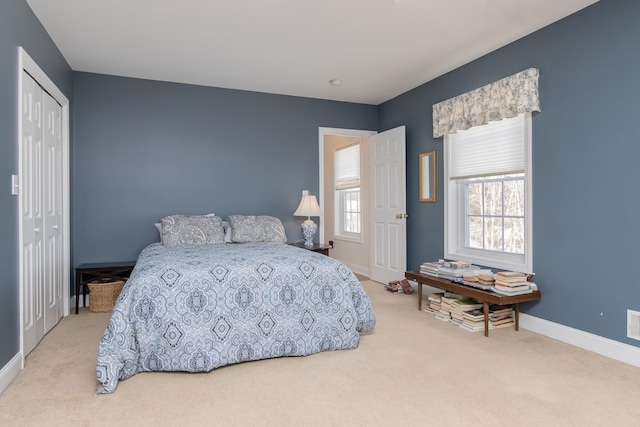 bedroom with carpet, a closet, and baseboards