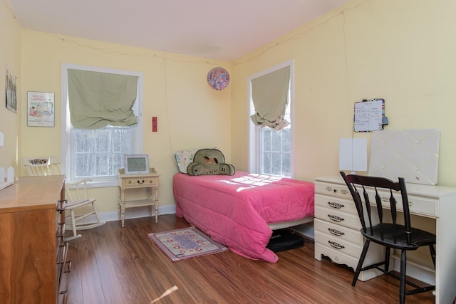 bedroom with dark wood-style floors and baseboards