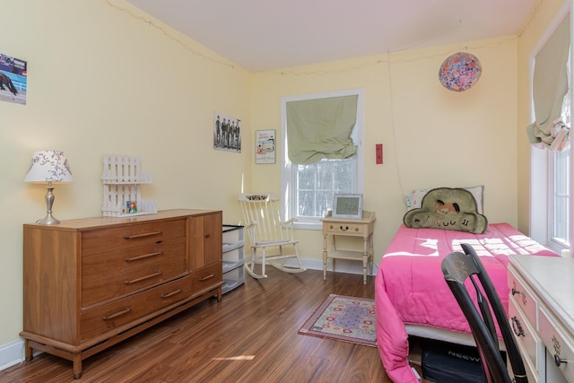 bedroom with dark wood-style floors and baseboards