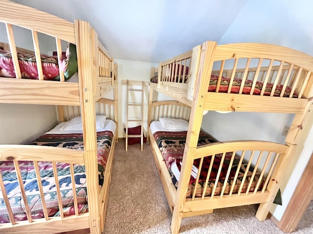 carpeted bedroom with vaulted ceiling