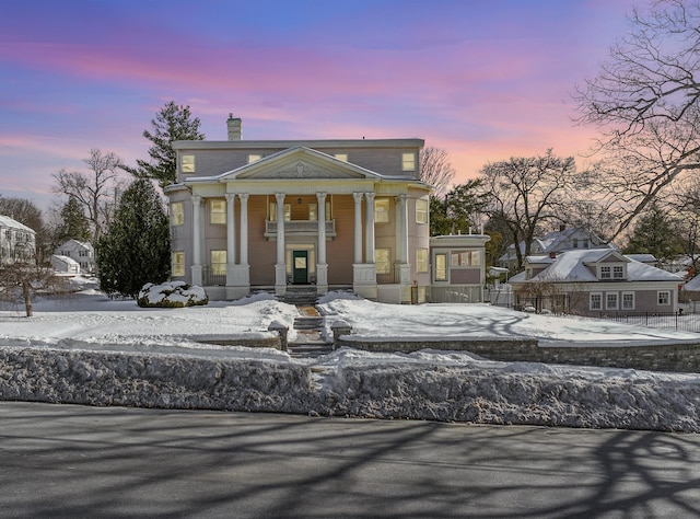 neoclassical / greek revival house with a chimney