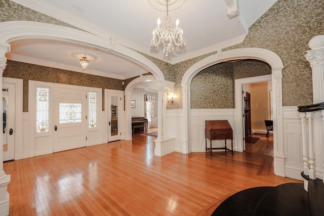 entryway featuring a wainscoted wall, light wood-type flooring, and wallpapered walls