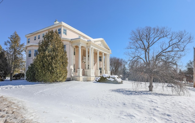 view of snow covered exterior featuring covered porch